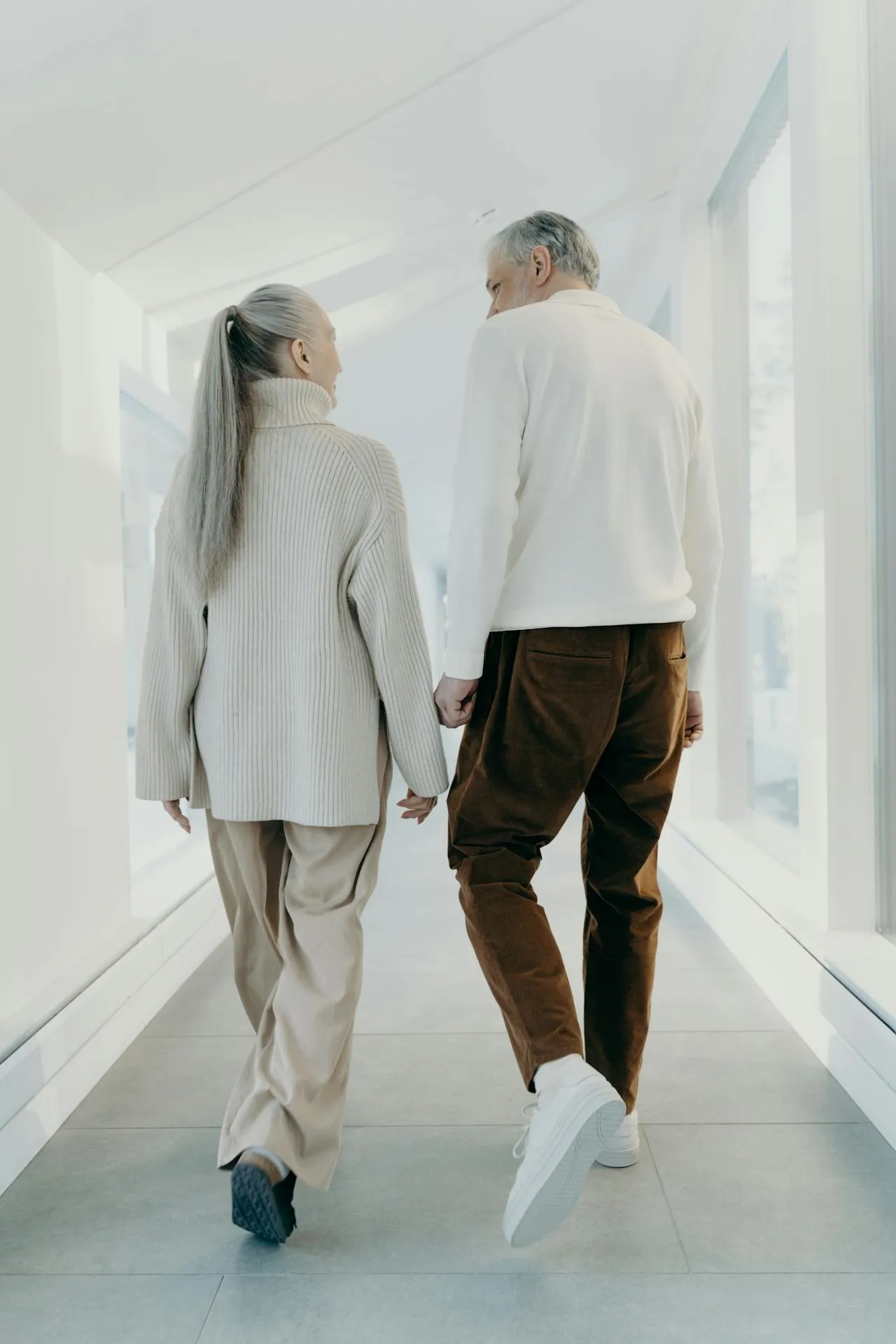 A placement specialist and a senior couple smiling together after finalizing care arrangements